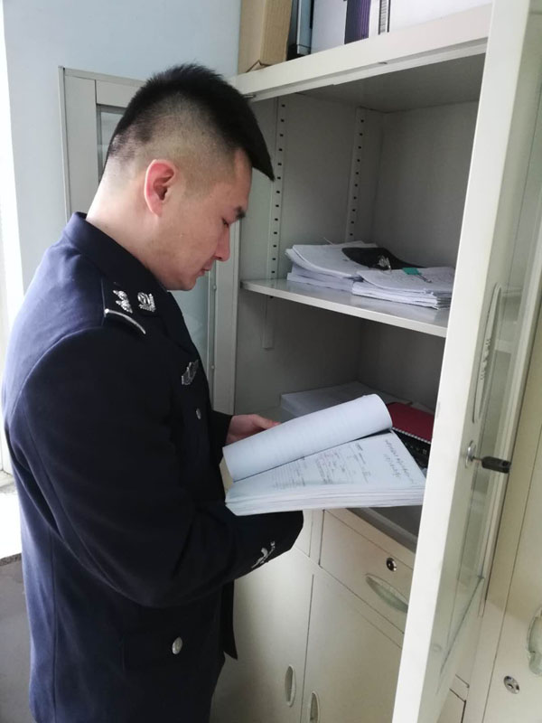 圖二，辛楊查閱卷宗，在一摞摞卷宗材料中尋找線索