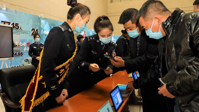 民警指導市民掃碼登錄“交管12123”APP。